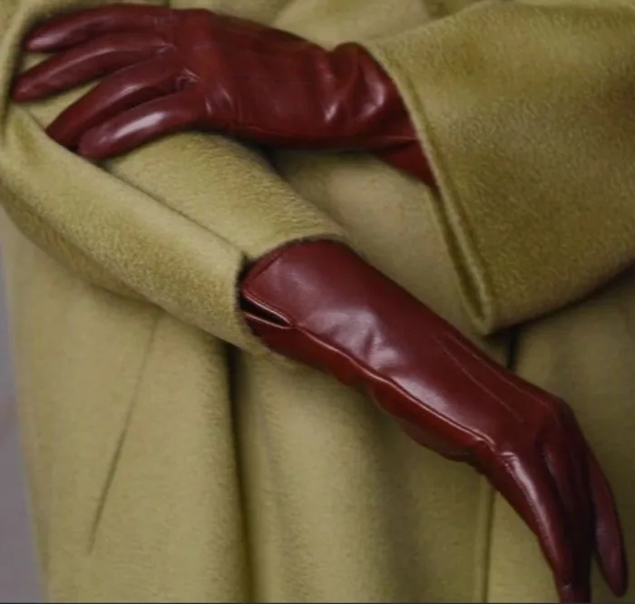 Burgundy leather gloves against an olive wool coat